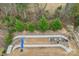 Aerial view of a landscaped backyard featuring stone terracing and a built-in seating area at 14621 Brannock Hills Dr, Charlotte, NC 28278