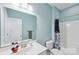 Clean bathroom with a white vanity, toilet, and shower with curtain at 14621 Brannock Hills Dr, Charlotte, NC 28278