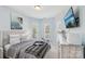 Bedroom with neutral paint, TV, gray comforter, and natural light from multiple windows at 14621 Brannock Hills Dr, Charlotte, NC 28278