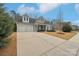 Charming home featuring a two-car garage, beautifully landscaped front yard, and inviting covered porch at 14621 Brannock Hills Dr, Charlotte, NC 28278