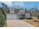 Charming home featuring a two-car garage, beautifully landscaped front yard, and inviting covered porch at 14621 Brannock Hills Dr, Charlotte, NC 28278