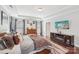 This main bedroom is equipped with a fireplace and television, hardwood floors, area rug and windows at 14621 Brannock Hills Dr, Charlotte, NC 28278