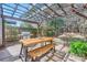 Outdoor dining area beneath a charming pergola, complete with a stainless steel grill and wooden picnic table at 1474 Callender Nw Ln, Charlotte, NC 28269