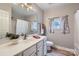 Bathroom featuring a vanity with a mirror, updated fixtures, and a shower-tub combo at 1474 Callender Nw Ln, Charlotte, NC 28269