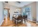 Bright dining room with hardwood floors, stylish lighting, and a view of the kitchen at 1474 Callender Nw Ln, Charlotte, NC 28269