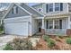 Charming home featuring a well-kept lawn, two-car garage, and a welcoming front porch at 1474 Callender Nw Ln, Charlotte, NC 28269