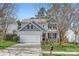 Charming two-story home with a well-manicured lawn, a front porch, and a two-car garage at 1474 Callender Nw Ln, Charlotte, NC 28269