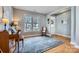 Bright living room featuring hardwood floors, a grand piano, and a cozy rocking chair at 1474 Callender Nw Ln, Charlotte, NC 28269