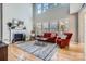 Bright living room with fireplace, hardwood floors, and large windows at 1474 Callender Nw Ln, Charlotte, NC 28269