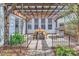 Relaxing patio with a wooden pergola, perfect for outdoor dining with a built-in grill and dining set at 1474 Callender Nw Ln, Charlotte, NC 28269