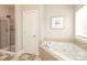 Bright bathroom featuring a walk-in shower, and soaking tub at 1512 Pecan Ave, Charlotte, NC 28205