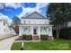 Charming two-story home with a welcoming front porch and well-manicured lawn at 1512 Pecan Ave, Charlotte, NC 28205