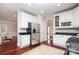 Modern kitchen with stainless steel appliances, an island, and white cabinetry at 1512 Pecan Ave, Charlotte, NC 28205