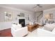 Bright and airy living room features a fireplace, ceiling fan, and access to the staircase at 1512 Pecan Ave, Charlotte, NC 28205