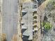 Drone shot of townhome roofs with a parking lot, backyard patios, and mature trees at 1559 Maypine Commons Way, Rock Hill, SC 29732