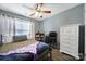 Bedroom features a ceiling fan, wood-look flooring, a window and a desk area at 1559 Maypine Commons Way, Rock Hill, SC 29732