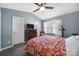 This bedroom features an ensuite bath, a ceiling fan, natural light and wood-look flooring at 1559 Maypine Commons Way, Rock Hill, SC 29732