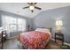 This bedroom features a vaulted ceiling, wood-look floors, natural light and a ceiling fan at 1559 Maypine Commons Way, Rock Hill, SC 29732