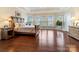 Bright bedroom with hardwood floors, tray ceiling and multiple windows for natural light at 16023 Rushwick Dr, Huntersville, NC 28078