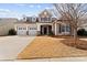 Charming two-story home featuring a three-car garage, manicured lawn, and inviting front porch at 16023 Rushwick Dr, Huntersville, NC 28078