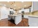 Modern kitchen with stainless steel appliances, granite countertops, white cabinets, and hardwood floors at 16023 Rushwick Dr, Huntersville, NC 28078