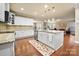 Spacious kitchen featuring a large island, stainless steel appliances, and hardwood floors at 16023 Rushwick Dr, Huntersville, NC 28078