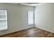 This bedroom features hardwood floors, neutral walls, and natural light from two windows with blinds at 1629 Backcreek Ln, Gastonia, NC 28054