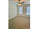 This carpeted bedroom provides neutral walls, ceiling fan, and natural light from two windows with blinds at 1629 Backcreek Ln, Gastonia, NC 28054