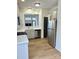 Well-lit kitchen with sleek white cabinets, stainless steel appliances, and hardwood floors at 1629 Backcreek Ln, Gastonia, NC 28054