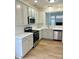 Modern kitchen featuring white cabinetry, stainless steel appliances, and tiled backsplash at 1629 Backcreek Ln, Gastonia, NC 28054