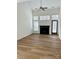 Spacious living room featuring a fireplace, large windows, and hardwood floors at 1629 Backcreek Ln, Gastonia, NC 28054