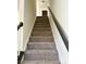 This carpeted stairway features a black handrail and leads to the upper level at 1629 Backcreek Ln, Gastonia, NC 28054