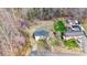 Aerial shot shows the property's location amidst a wooded area with a large backyard at 1740 Young Dr, Conover, NC 28613