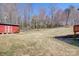 Large backyard features a red shed, mature trees, and plenty of open space at 1740 Young Dr, Conover, NC 28613