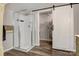 Modern bathroom featuring a glass-enclosed shower and sliding barn door leading to a walk-in closet at 1740 Young Dr, Conover, NC 28613