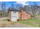 Side view of a brick two-story home featuring an attached one-car garage and a well-maintained lawn at 1740 Young Dr, Conover, NC 28613