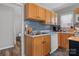 The kitchen features stainless steel sink, dishwasher and mosaic backsplash at 1740 Young Dr, Conover, NC 28613