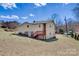 Two-story home boasts beige siding and a red stairway with a spacious backyard on a bright, sunny day at 1740 Young Dr, Conover, NC 28613