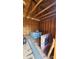 Interior view of shed reveals trussed ceiling and storage space with television box, water bottles and drainage grate at 1740 Young Dr, Conover, NC 28613