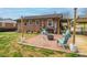 Brick patio with outdoor seating around a fire pit, surrounded by a well-maintained lawn and mature landscaping at 198 33Rd Nw St, Hickory, NC 28601