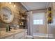 Charming bathroom featuring wooden accent wall, round mirror, and modern fixtures at 198 33Rd Nw St, Hickory, NC 28601