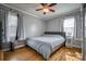 Bright bedroom featuring hardwood floors, ceiling fan, and natural light from two windows at 198 33Rd Nw St, Hickory, NC 28601