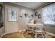 Cozy breakfast nook features a white round table and three chairs near the door and window at 198 33Rd Nw St, Hickory, NC 28601