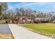 Single-story brick home features a covered porch, a long driveway, and a well-manicured lawn and a neighboring house at 198 33Rd Nw St, Hickory, NC 28601