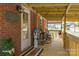 Inviting front porch featuring rocking chairs, decorative accents, and a welcoming entrance with a brick facade at 198 33Rd Nw St, Hickory, NC 28601