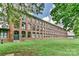 Beautiful brick building with many windows, surrounded by lush green grass and trees at 201 S Hoskins Rd # 131, Charlotte, NC 28208