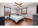 Comfortable bedroom featuring hardwood floors, neutral walls, ceiling fan, and natural light from the windows at 201 Wiley Ave, York, SC 29745