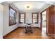 Dining area with hardwood floors, glass top table, and three windows for natural light at 201 Wiley Ave, York, SC 29745