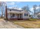 Bungalow-style home with brick accents, front porch with swing, and tidy lawn with space for parking at 201 Wiley Ave, York, SC 29745