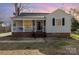 Charming bungalow-style home with a welcoming front porch, brick foundation, and neutral siding at 201 Wiley Ave, York, SC 29745